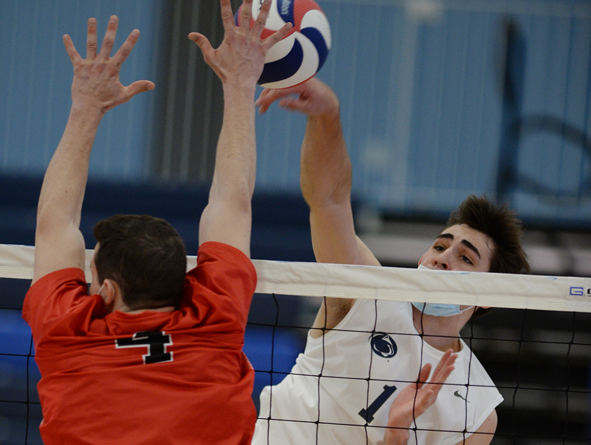 Photo by Gary M. Baranec: Penn State Altoona&rsquo;s Philip Silva hits past LBC's Kyran Flahive on Saturday at the Adler Arena.