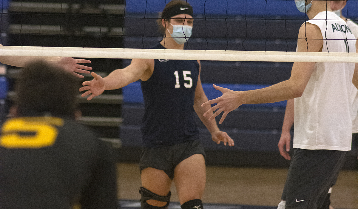 Photo (by Earl Kufen): Junior libero Micah Brinker celebrates with teammates after a point during Wednesday night's win over St. Vincent in the Adler Arena.