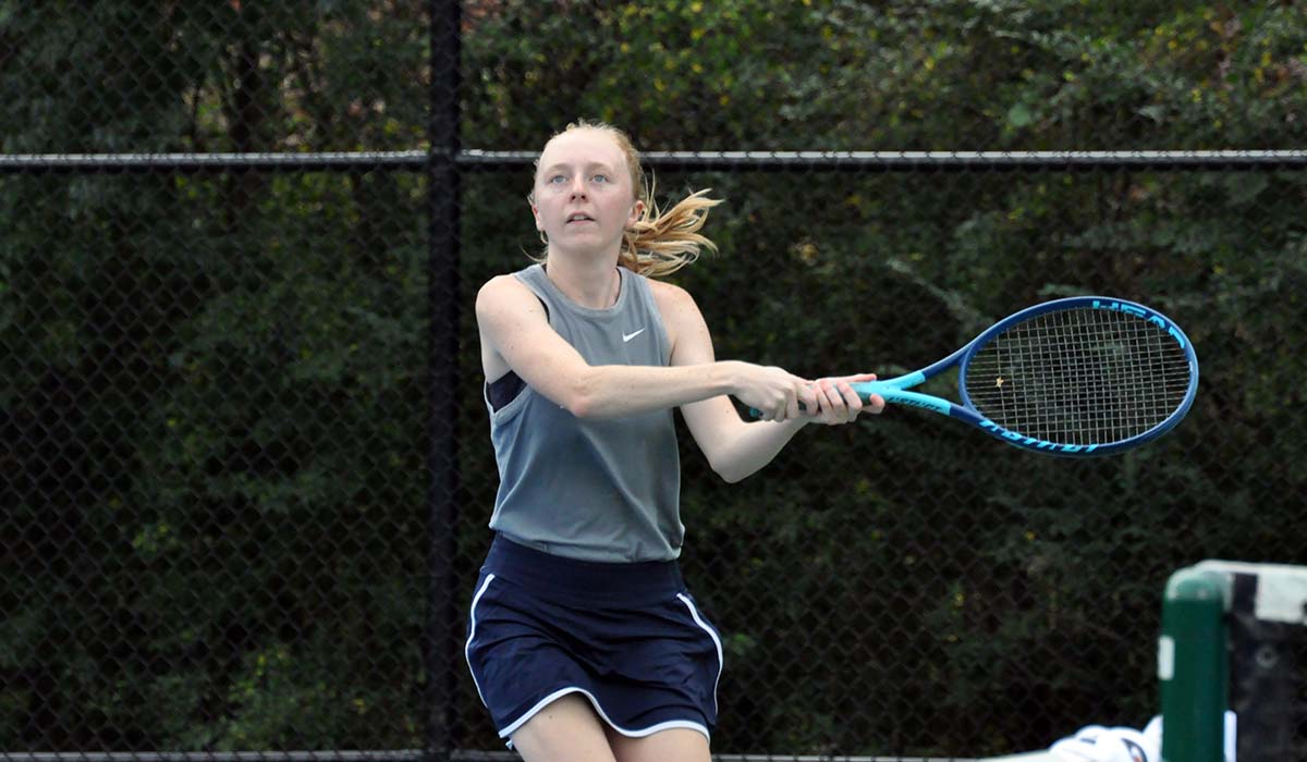 Photo: Junior Jenna Bartlett readies to hit a backhand during doubles on Sunday against Pitt-Bradford.