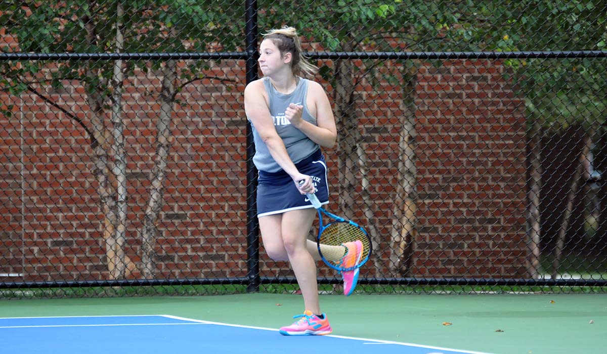 Photo: Freshman Caitlyn Dale follows through on a swing during Thursday's win over La Roche.